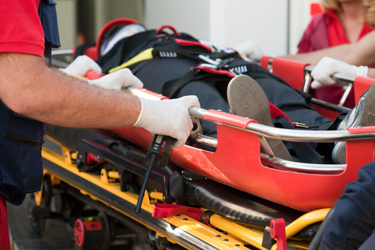 paramedics rushing patient into an ambulance