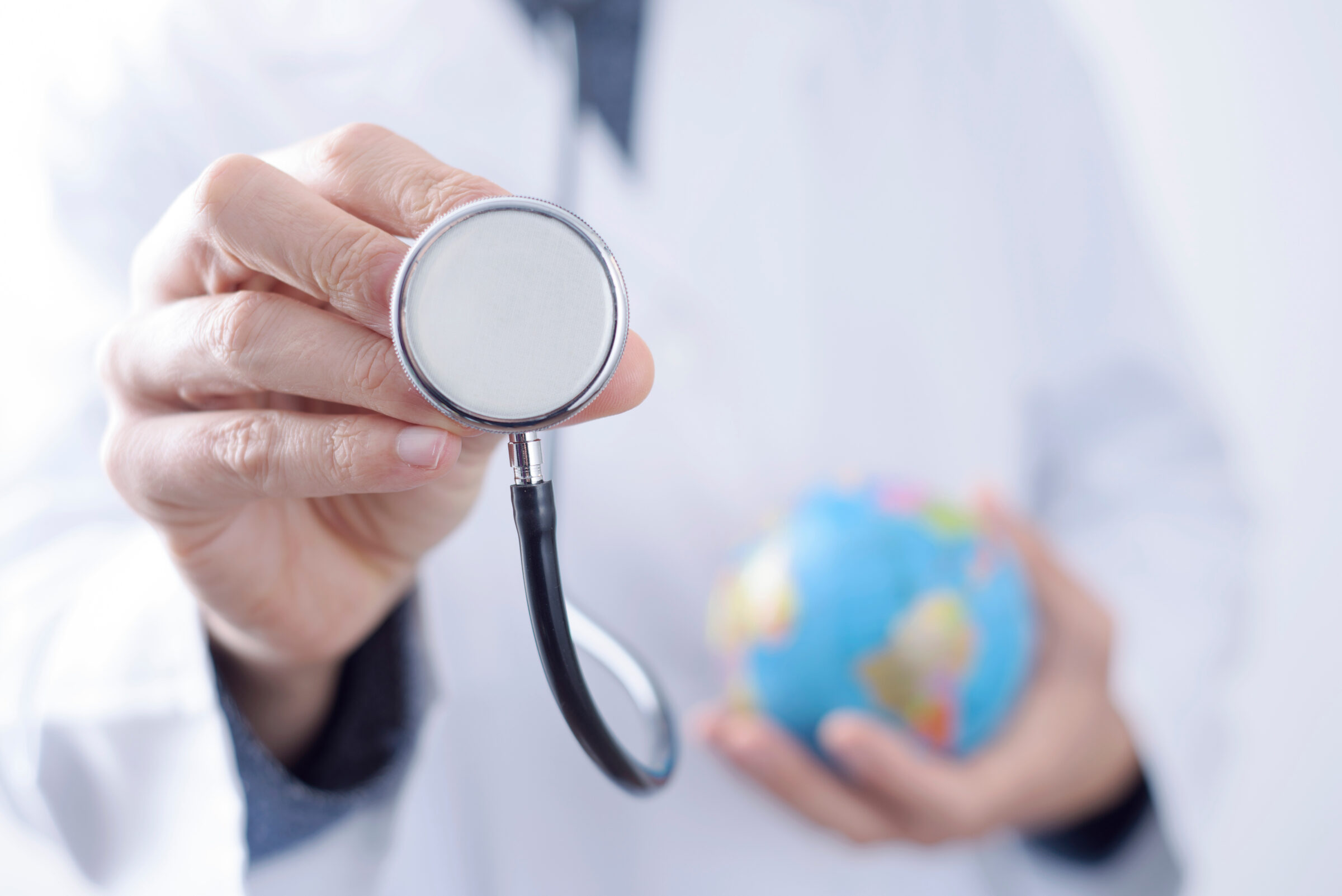 doctor with a stethoscope and a world globe.