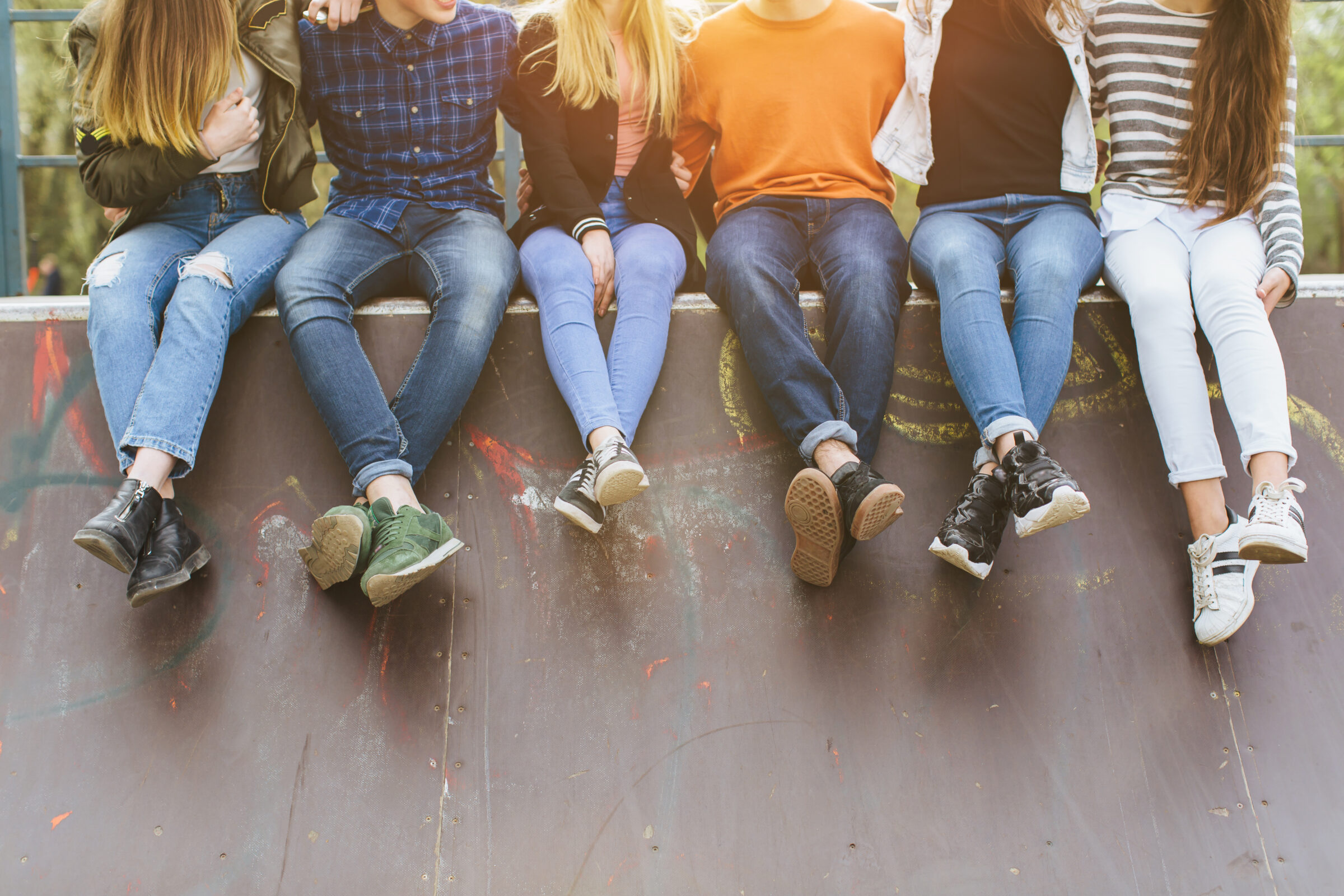 Group of teenagers sitting on wall