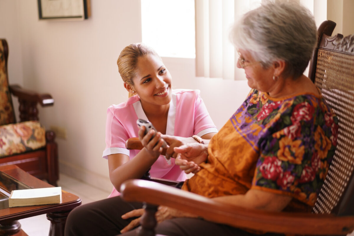 Hospice Nurse Helps Old Lady With Mobile Phone Call