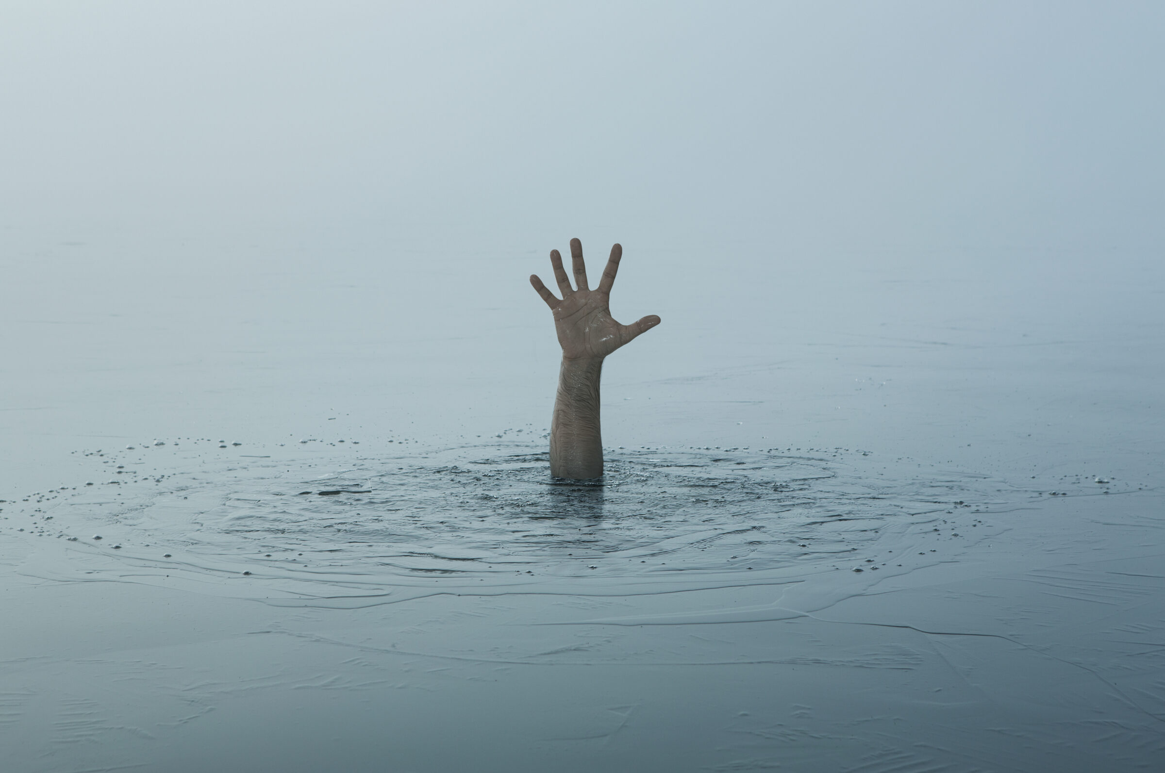 Danger, problems concept. Close up of human hand drowning in the lake