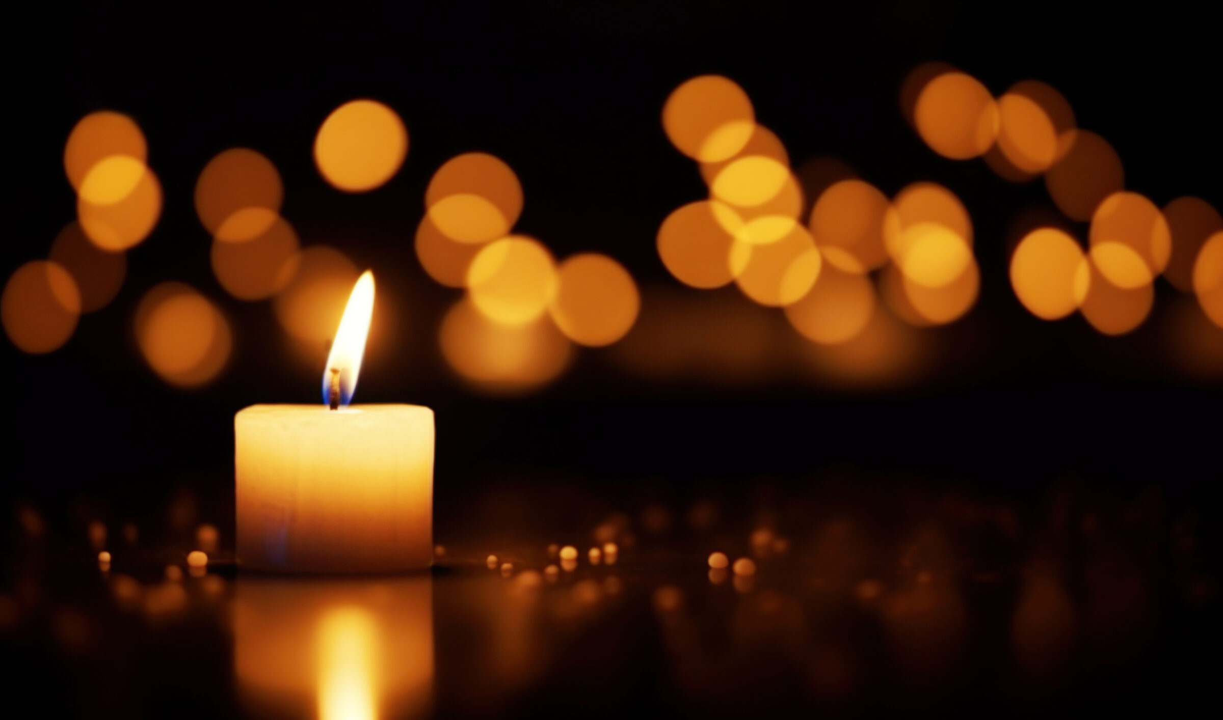 Burning candle on a black background