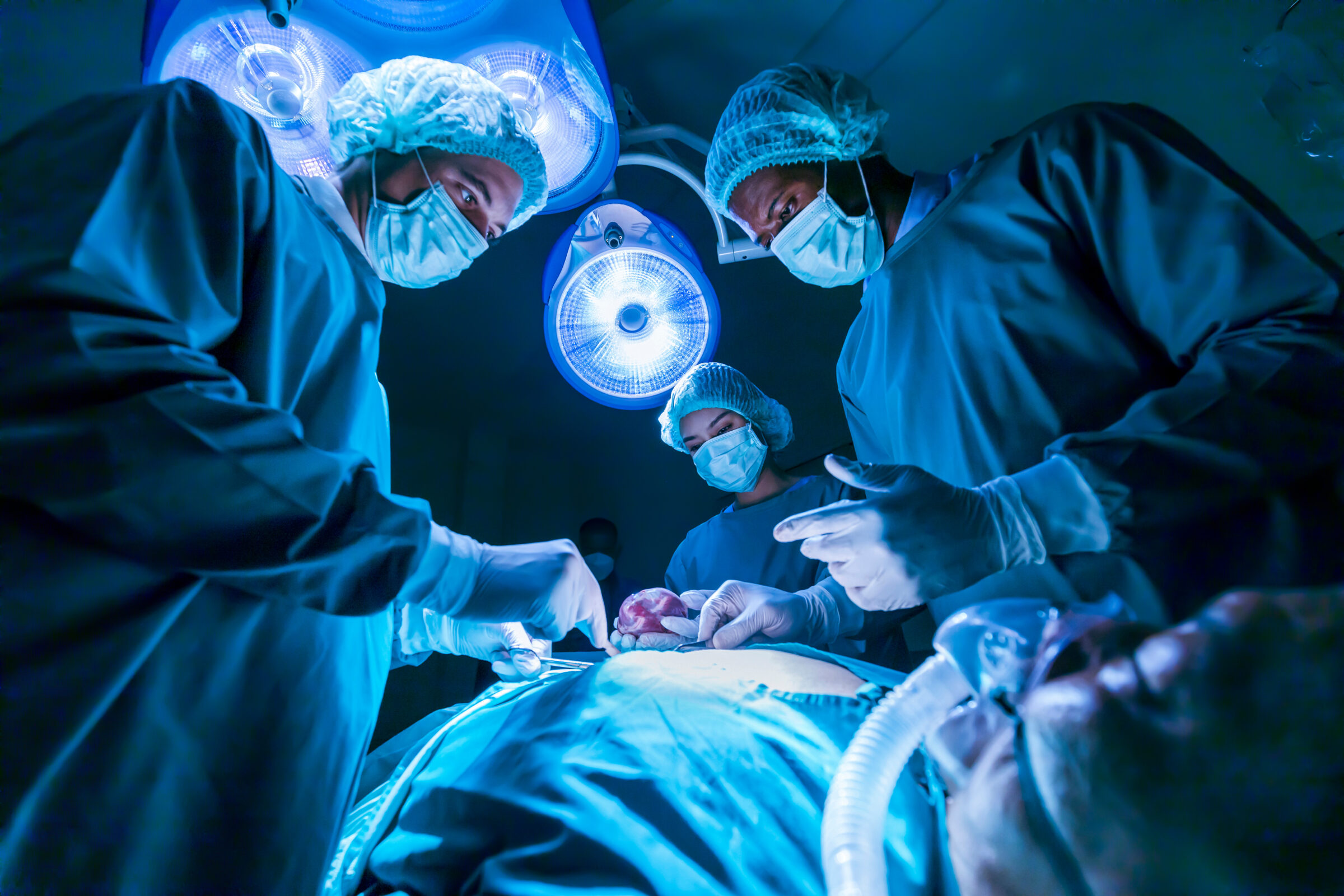 Team of surgeon doctors are performing heart surgery operation for patient from organ donor to save more life in emergency surgical room