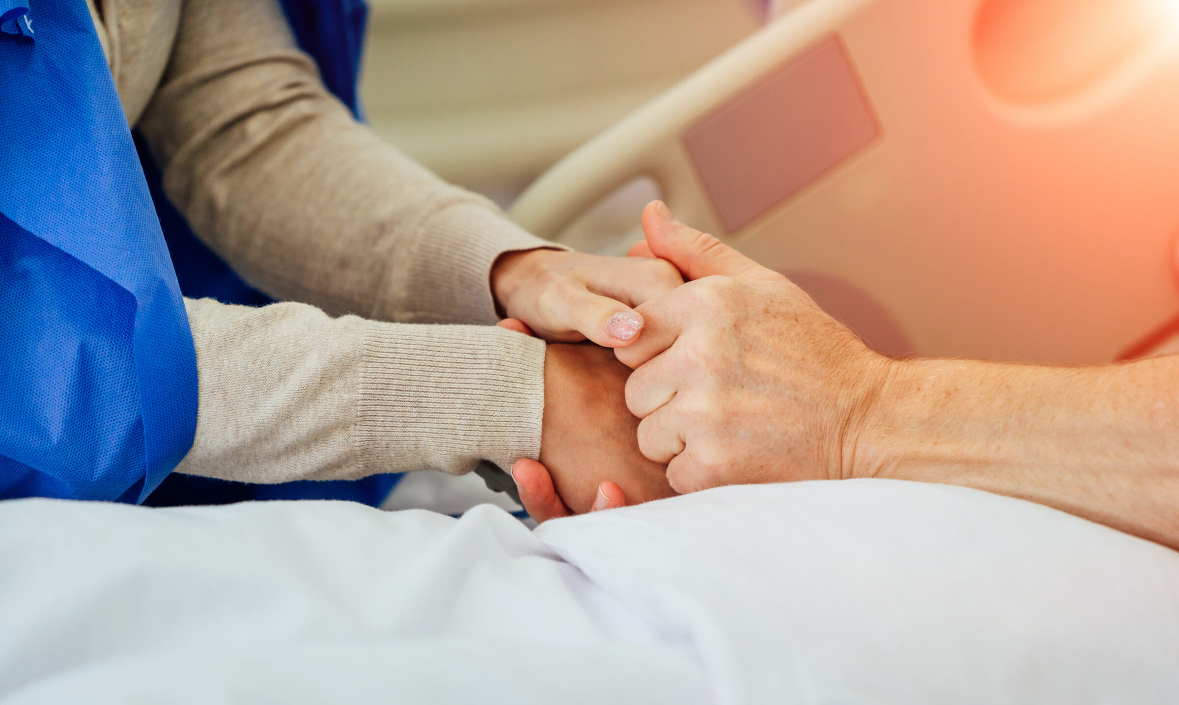 Holding patient hands in a hospital. Family help. Closeup. Support.