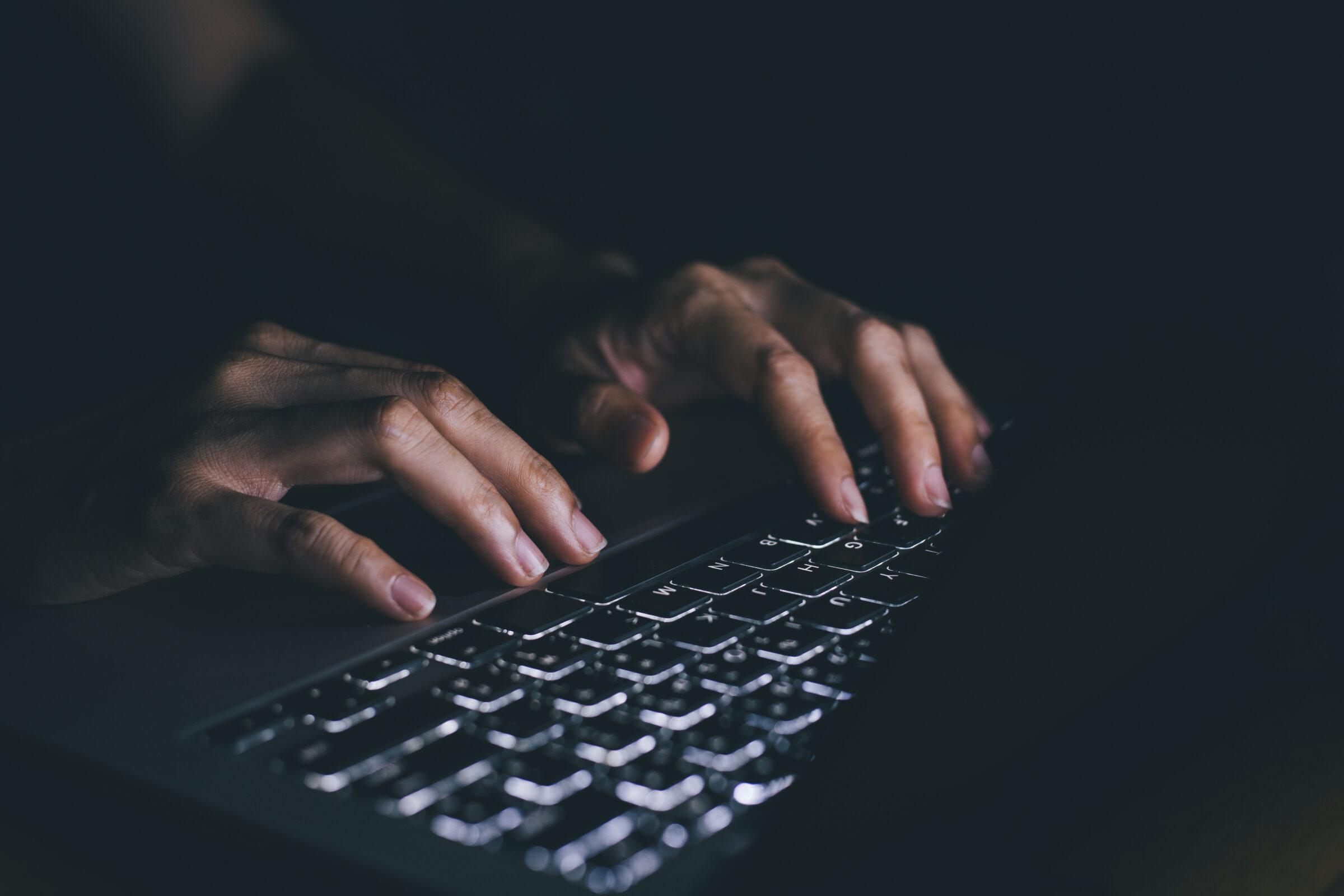using computer.hand typing message on keyboard laptop chatting friend and search information form internet